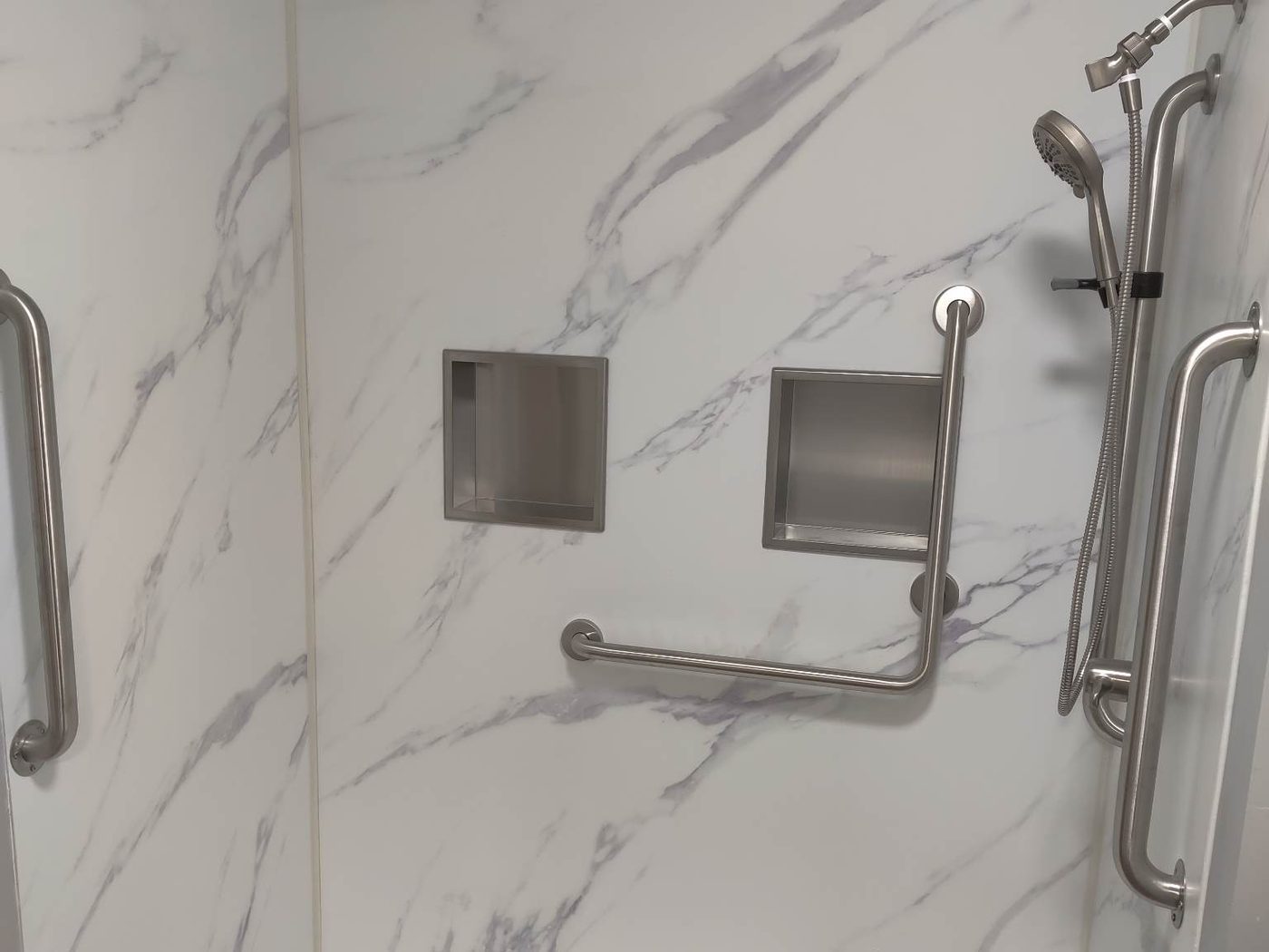 Accessible walk-in shower with grab bars by KZ Contractors